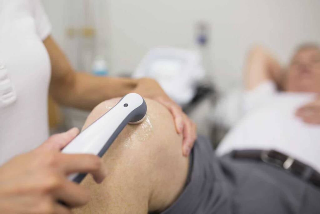 Can Ultrasound Therapy Cause Cancer? Here’s What Science Really Says 1 Physiotherapist applying ultrasound therapy to a patient’s knee for pain relief in a clinical setting